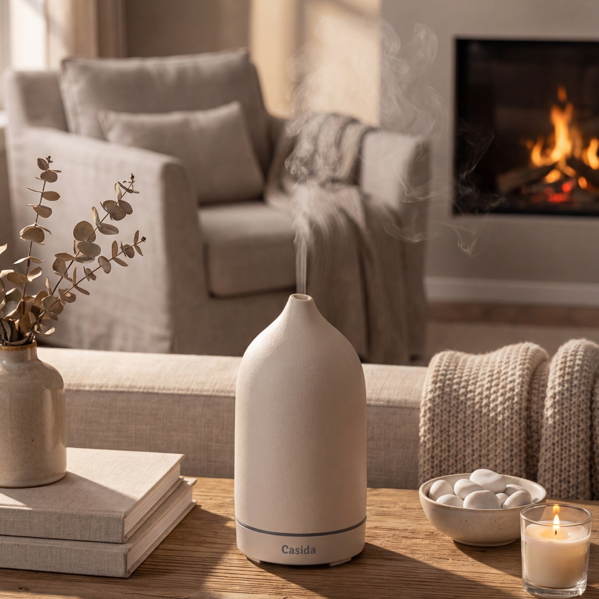 Keramik Aroma Diffuser in white with steam, placed on a wooden table near a cozy living room setting.
