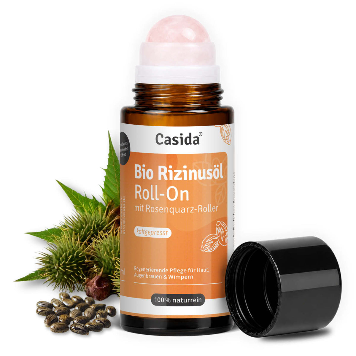 Geöffneter Casida Bio Rizinusöl Roll-On mit rosa Rosenquarz-Kugel neben Rizinusfrüchten und Samen