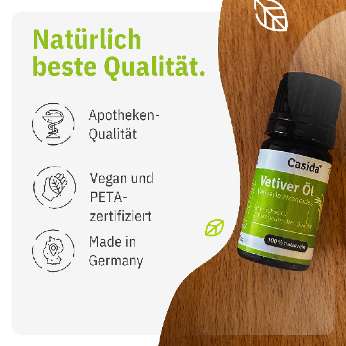 Casida vetiver oil bottle on a wooden surface, featuring labels with vegan and PETA-certified icons.