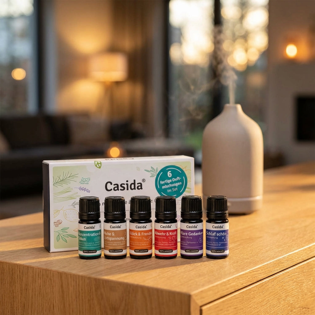 Duftmischungen TOP 6 set with six essential oil bottles and a diffuser on a wooden table, soft lighting in the background.