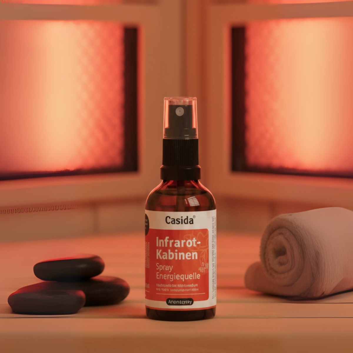 Infrarotkabinen spray "Energiequelle" bottle on a wooden surface with infrared heating panels and stones in the background.