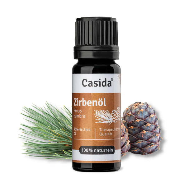 Zirbenöl in a black bottle with a brown label, surrounded by pine branches and pine cones.